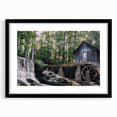Framed wall art showcasing a serene landscape of a watermill, featuring a black frame and mat, perfect for enhancing home decor with nature-inspired elegance. Ideal for living spaces, this artwork adds a tranquil touch to any interior.