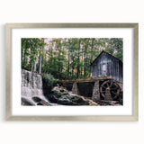 Framed wall art featuring a serene watermill landscape design, elegantly matted and bordered in silver, perfect for enhancing home decor with a tranquil vibe.