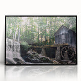 Framed acrylic wall art featuring a serene landscape design of a watermill, presented with a sleek black frame, enhancing home decor aesthetics. Ideal for nature lovers seeking elegant wall art.