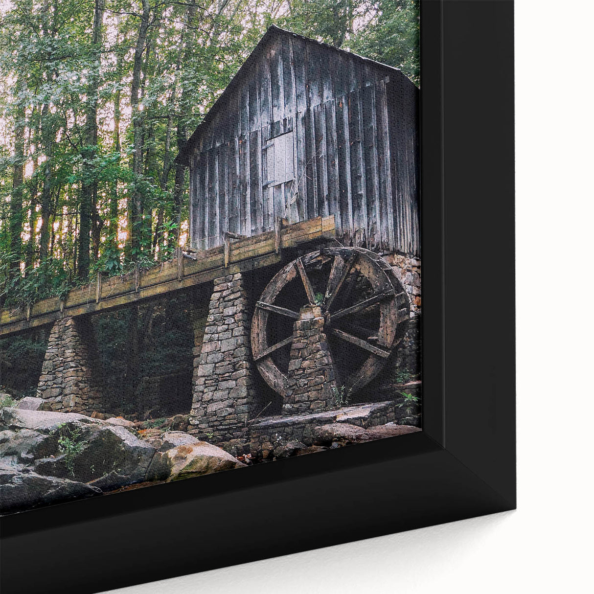 Framed canvas wall art depicting a serene watermill landscape, showcasing vibrant greens and blues, ideal for home decor and nature-inspired themes.