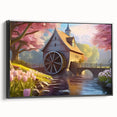 Framed canvas wall art depicting a serene watermill landscape, featuring rich greens and blues, with a black frame and side view showcasing its elegant design.