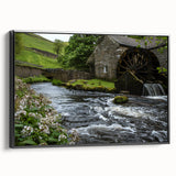 Framed canvas wall art featuring a serene watermill landscape design, showcasing vibrant colors and intricate details, displayed from a black side view.