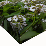 Close-up of a stretched canvas featuring a vibrant landscape design with a serene watermill, showcasing rich colors and intricate details, perfect for home decor.