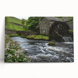 Stretched canvas wall art showcasing a serene watermill landscape design, highlighting lush greenery and a tranquil stream, perfect for home decor accents.