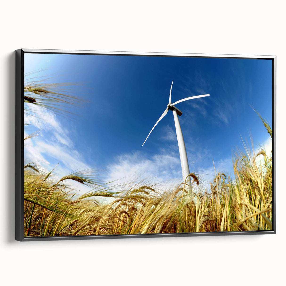 Framed canvas wall art featuring a scenic landscape with windmills against a vibrant sunset, showcasing deep blues and warm oranges, perfect for home decor.