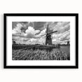 Framed wall art collection showcasing a serene landscape with windmills, featuring a matte black frame, perfect for modern home decor. Ideal for adding a touch of tranquility to any living space.