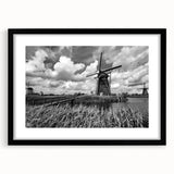 Framed wall art collection showcasing a serene landscape with windmills, featuring a matte black frame, perfect for modern home decor. Ideal for adding a touch of tranquility to any living space.