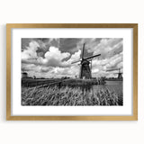 Framed wall art collection featuring a picturesque landscape with windmills, set in a gold frame and matting, ideal for home decor enhancement.