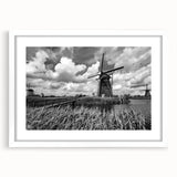 Framed wall art collection featuring a serene landscape with windmills, showcasing a white mat and frame, perfect for enhancing modern home decor.