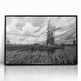 Framed acrylic wall art showcasing a scenic landscape with windmills, featuring a black frame and a vivid color palette, perfect for home decor.