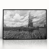 Framed acrylic wall art showcasing a scenic landscape with windmills, featuring a black frame and a vivid color palette, perfect for home decor.