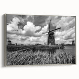 Framed canvas wall art showcasing a serene landscape with windmills, accented by a silver frame, ideal for home decor and modern aesthetics.