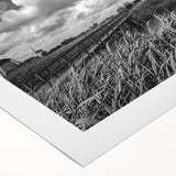 Rolled canvas art print showcasing a serene landscape with windmills against a vibrant sunset, perfect for home decor and adding a touch of tranquility to any room.