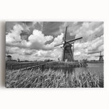 Stretched canvas wall art showcasing a picturesque landscape with windmills against a vibrant sunset, perfect for enhancing home decor and adding a serene touch to any space.