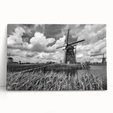 Stretched canvas wall art showcasing a serene landscape with windmills under a bright blue sky, ideal for home decor. Perfect for adding a touch of tranquility.