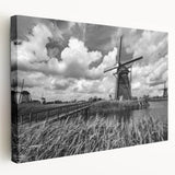 Stretched canvas wall art featuring a serene landscape with windmills, vibrant colors of blue and green, designed to enhance home decor and evoke tranquility.