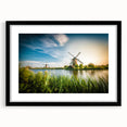 Framed wall art featuring a picturesque landscape with windmills, showcasing a black mat and frame for an elegant finish, ideal for home decor.