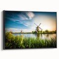 Framed canvas wall art showcasing a serene landscape of windmills against a sunset background, featuring a black frame, enhancing modern decor aesthetics.
