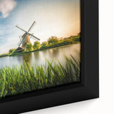Framed canvas wall art showcasing a vibrant landscape with windmills under a bright blue sky, featuring rich colors and intricate details, ideal for home decor.
