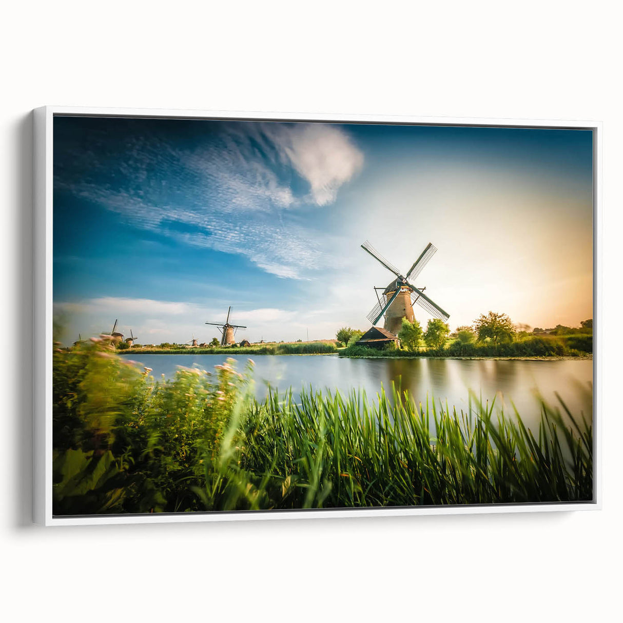 Framed canvas wall art showcasing a scenic landscape with windmills, set against a clear blue sky and lush green fields, perfect for home decor.