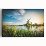 Stretched canvas wall art featuring a scenic landscape with windmills against a vibrant sunset sky, ideal for home decor. Perfect blend of nature and artistry.