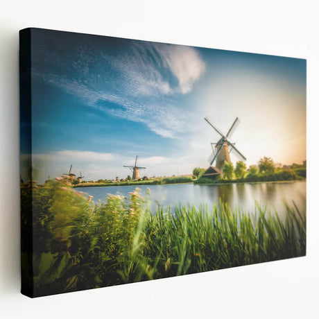 Stretched canvas wall art showcasing a serene landscape with windmills under a vibrant sunset, perfect for adding a tranquil touch to home decor.
