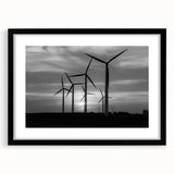 Black-framed wall art showcasing a serene landscape with windmills, designed with a modern aesthetic and featuring a white mat to enhance its elegance. This piece adds a touch of sophistication to any interior decor.