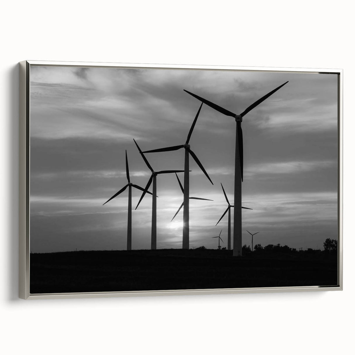 Framed canvas wall art featuring a serene landscape with windmills, set against a silver frame, showcasing a tranquil rural scene ideal for home decor.