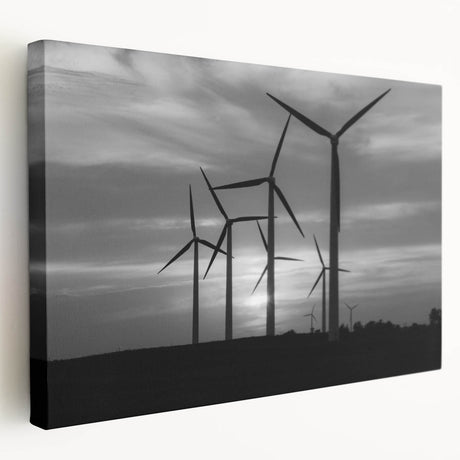 Stretched canvas wall art showcasing a serene landscape with windmills against a vibrant sunset, ideal for home decor. Perfect for adding a touch of tranquility to any room.