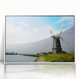 Framed acrylic wall art featuring a vibrant landscape with windmills, set against a serene sky, designed to enhance modern decor with its white frame and artistic flair.