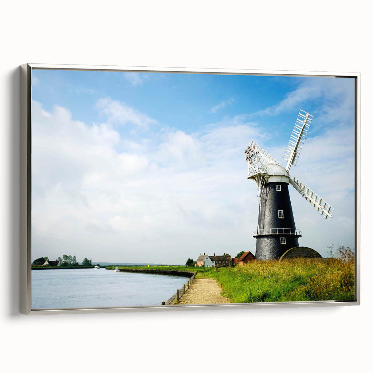 Framed canvas wall art showcasing a serene landscape with windmills, featuring a silver frame and vibrant colors, perfect for enhancing modern home decor.