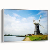 Framed canvas wall art showcasing a serene landscape with windmills, featuring a white frame and side view perspective, perfect for home decor enhancement.