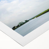 Vibrant rolled canvas showcasing a picturesque landscape with windmills against a bright blue sky, perfect for home decor or art enthusiasts.