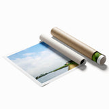 Rolled print showcasing a serene landscape of windmills against a vibrant sunset, ideal for home decor. The artwork emphasizes warm colors and tranquil scenery.