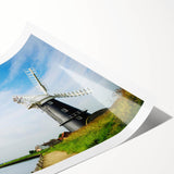 Stylish rolled print showcasing a vibrant landscape with windmills, featuring a blend of earthy tones and blue skies, ideal for home decor and art enthusiasts.
