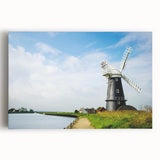 Stretched canvas wall art showcasing a vibrant landscape with windmills, featuring a colorful sunset backdrop and detailed foreground elements, perfect for home decor.