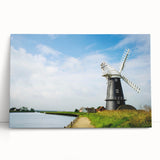 Stretched canvas wall art featuring a picturesque landscape with windmills, showcasing vibrant colors and serene skies, ideal for home decor.