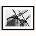 Framed wall art featuring a serene landscape with windmills, showcased in a sleek black frame with matting, perfect for enhancing modern home decor.