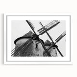 Framed wall art featuring a serene landscape scene with windmills, presented in a sleek white frame with a matte finish, ideal for home decor enhancement.