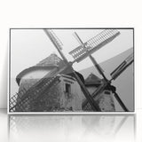 Framed acrylic wall art showcasing a serene landscape with windmills, set in a sleek white frame. Ideal for enhancing modern decor in living spaces.