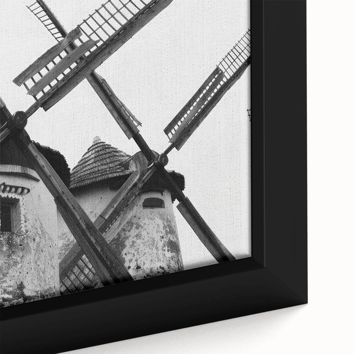 Close-up of a framed canvas wall art piece depicting a serene landscape with windmills, showcasing soft pastel colors and intricate detailing, perfect for home decor.