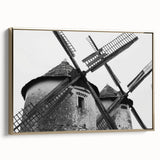 Framed canvas wall art showcasing a serene landscape with windmills, highlighted by gold accents and a side view perspective, ideal for home decor.