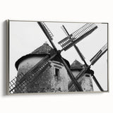 Framed canvas wall art showcasing a serene landscape with windmills, highlighted by silver framing and a contemporary design, perfect for modern home decor.