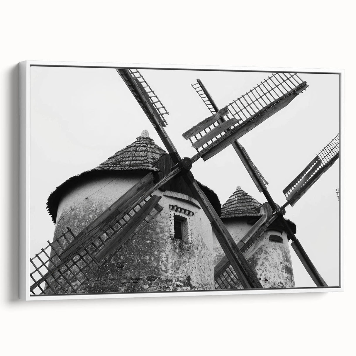 Framed canvas wall art showcasing a serene landscape with windmills against a bright blue sky, ideal for home decor. Perfect for adding a touch of tranquility to any room.