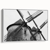 Framed canvas wall art showcasing a serene landscape with windmills against a bright blue sky, ideal for home decor. Perfect for adding a touch of tranquility to any room.