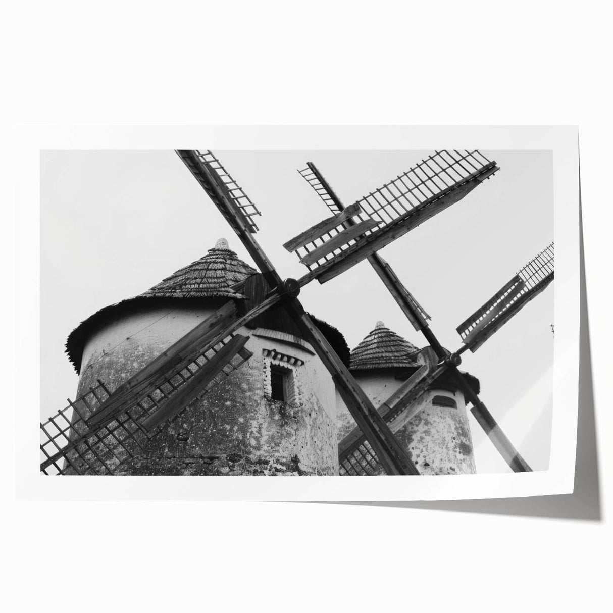 Vibrant rolled print of a serene landscape featuring windmills against a sunset backdrop, ideal for home decor or office art collection, showcasing natural beauty and tranquility.