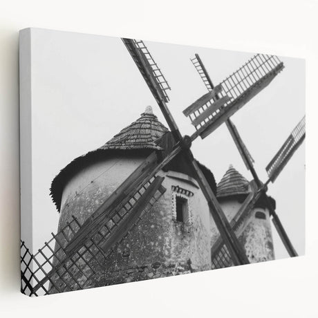 Stretched canvas wall art showcasing a serene landscape with windmills, vibrant colors, and soft clouds, perfect for adding a tranquil touch to any space.