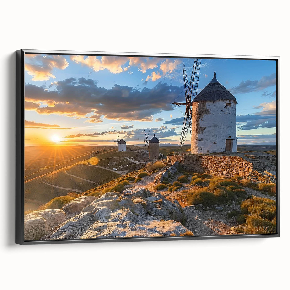 Framed canvas wall art showcasing a scenic landscape with windmills, featuring a sleek black frame and vibrant colors, ideal for enhancing modern home decor.