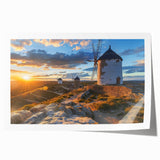 Rolled print showcasing a serene landscape with windmills against a colorful sunset, ideal for home decor, available in a protective cardboard tube.