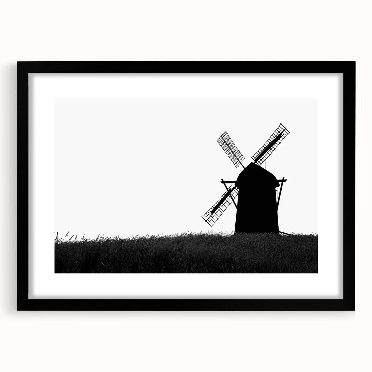 Framed wall art showcasing a serene landscape with windmills, featuring a sleek black frame and white matting, perfect for enhancing home decor aesthetics.